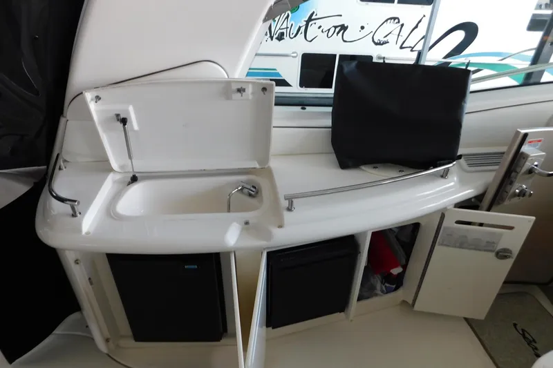 Slide: The Image of 2004 Sea Ray 500 Sundancer yacht interior with sink and storage compartments. - 49