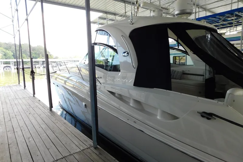 Slide: The Image of 2004 Sea Ray 500 Sundancer yacht docked in a marina, side view. - 50