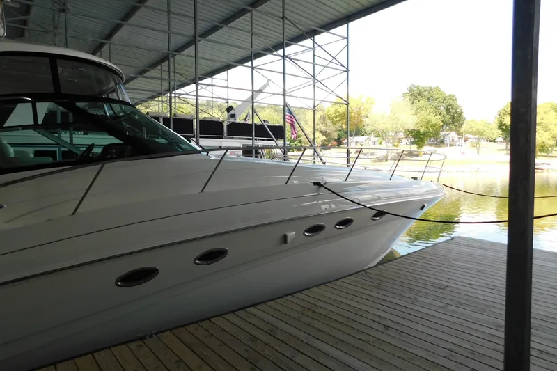 Slide: The Image of 2004 Sea Ray 500 Sundancer yacht docked under a covered marina. - 53