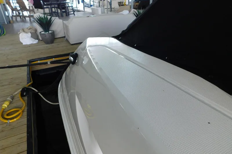 Slide: The Image of 2004 Sea Ray 500 Sundancer yacht docked indoors, showcasing sleek design and detailing. - 54