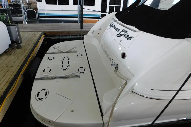Slide: The Image of 2004 Sea Ray 500 Sundancer yacht docked, featuring a spacious swim platform. - 55