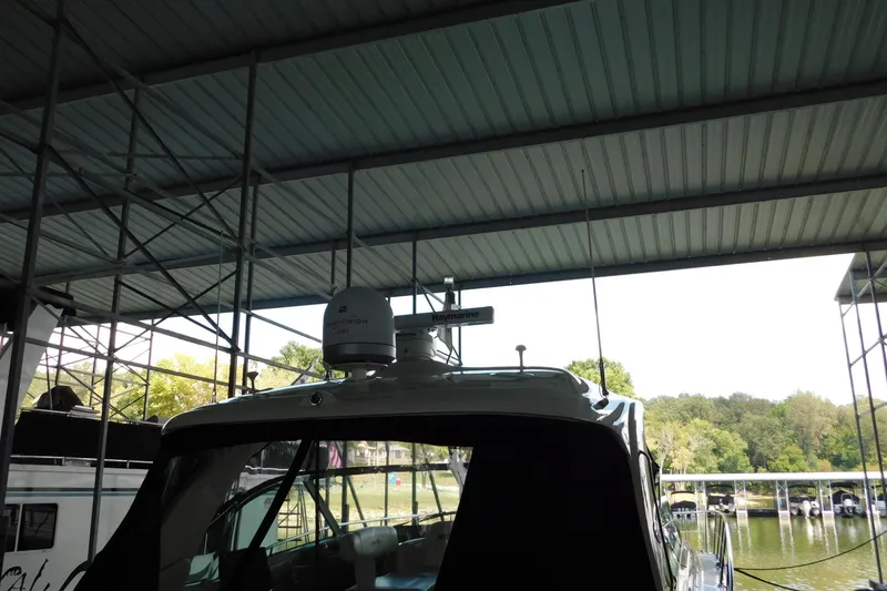 Slide: The Image of 2004 Sea Ray 500 Sundancer yacht docked under a covered marina. - 56