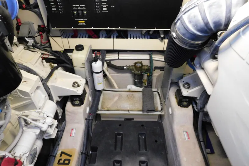 Slide: The Image of Engine room of a 2004 Sea Ray 500 Sundancer yacht, showcasing mechanical components. - 58