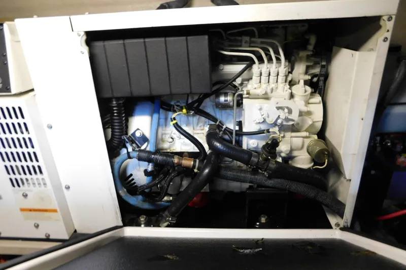 Slide: The Image of Engine compartment of a 2004 Sea Ray 500 Sundancer boat, showcasing mechanical components. - 63