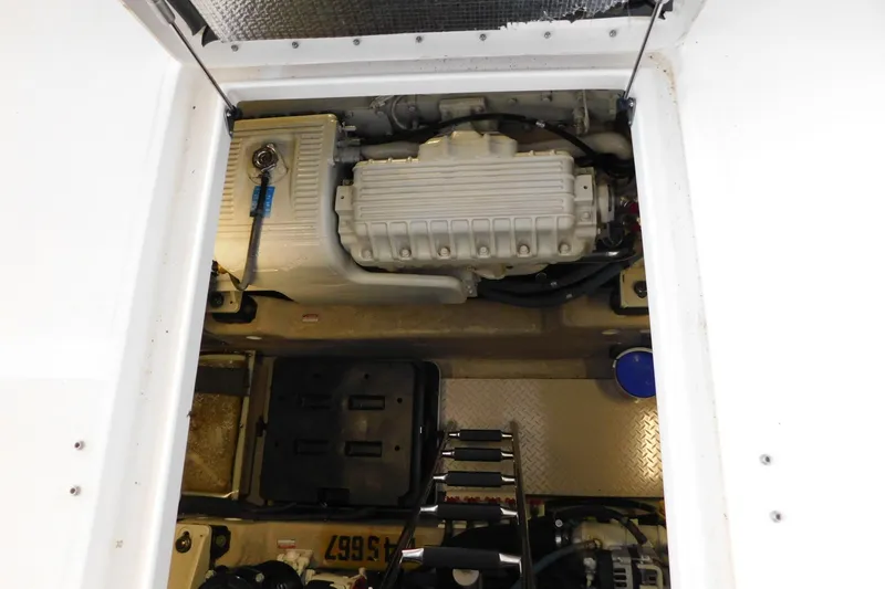 Slide: The Image of Engine compartment of 2004 Sea Ray 500 Sundancer, showcasing mechanical components and storage area. - 65