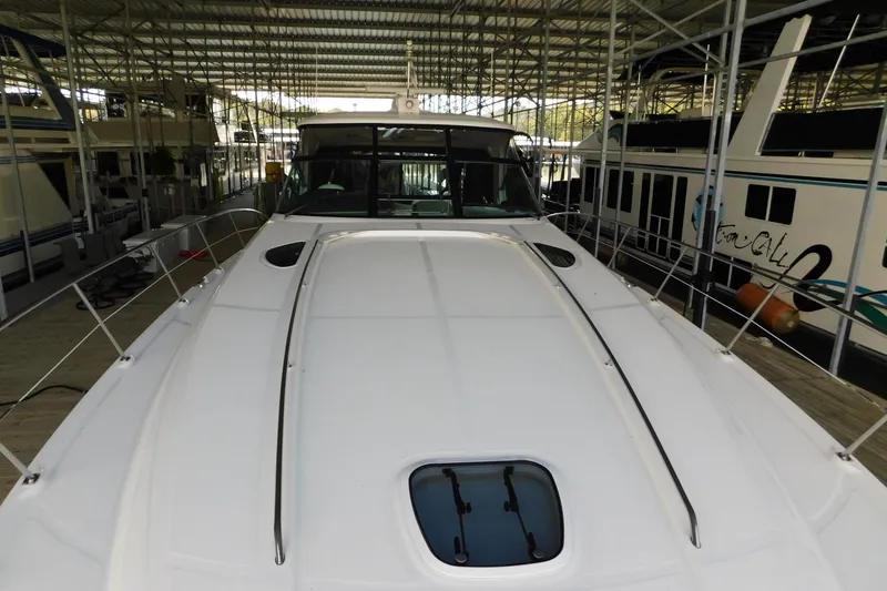 Slide: The Image of 2004 Sea Ray 500 Sundancer yacht docked in a covered marina. - 68