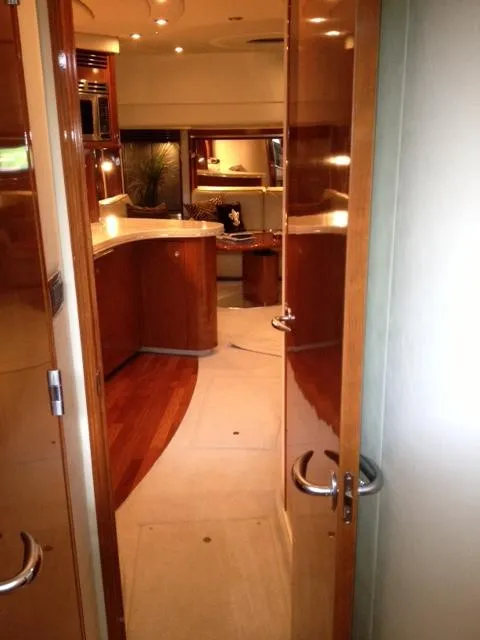 Slide: The Image of Interior view of 2004 Sea Ray 500 Sundancer yacht, featuring elegant wood finishes and modern design. - 7