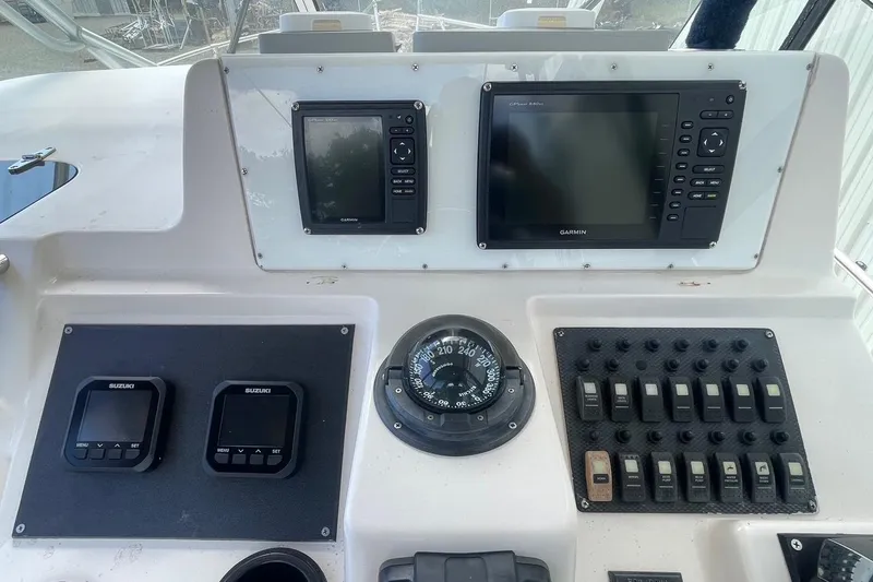 Slide: The Image of Control panel of a 2001 Grady-White Sailfish 255 boat with Garmin displays. - 10