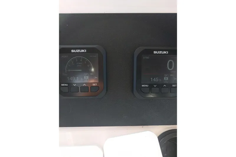 Slide: The Image of Suzuki digital gauges on a 2001 Grady-White Sailfish 282 boat dashboard. - 11