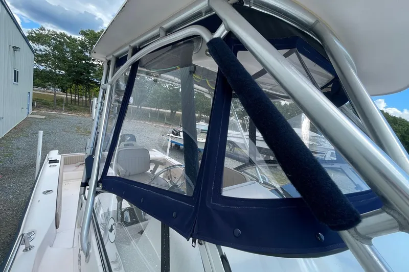 Slide: The Image of 2001 Grady-White Sailfish 255 boat with blue canopy and stainless steel frame. - 16