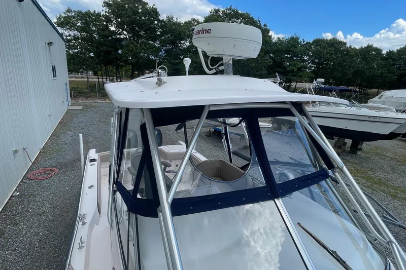 Slide: The Image of 2001 Grady-White Sailfish 255 boat with radar, docked outdoors. - 17
