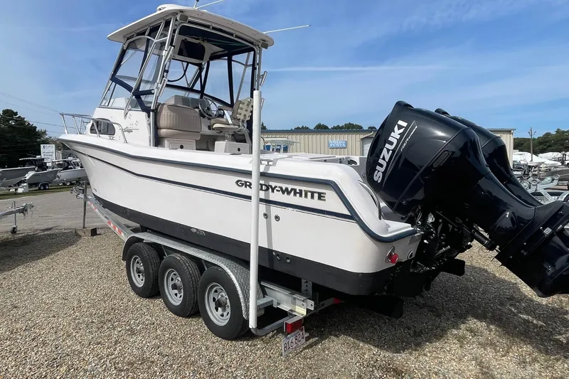 Slide: The Image of 2001 Grady-White Sailfish 255 boat with Suzuki outboard engine on a trailer. - 2