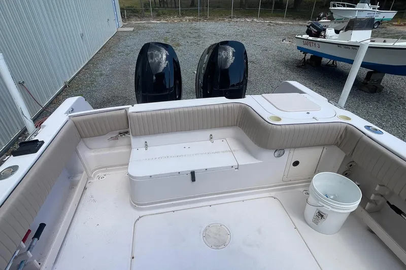 Slide: The Image of 2001 Grady-White Sailfish 255 boat interior with twin engines and seating area. - 21