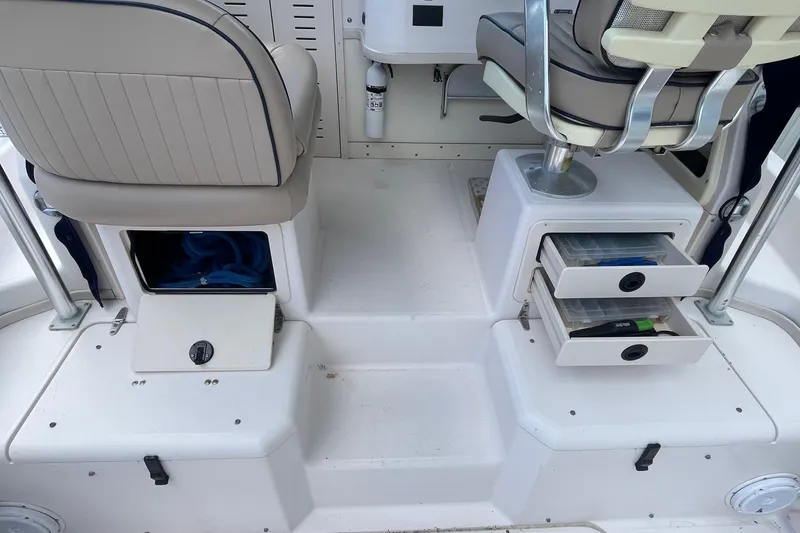 Slide: The Image of 2001 Grady-White Sailfish 255 boat interior with storage compartments and seating. - 24