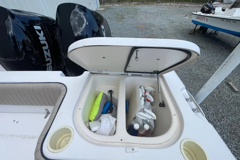 Slide: The Image of Open storage compartment on 2001 Grady-White Sailfish 255 boat with cleaning supplies. - 25