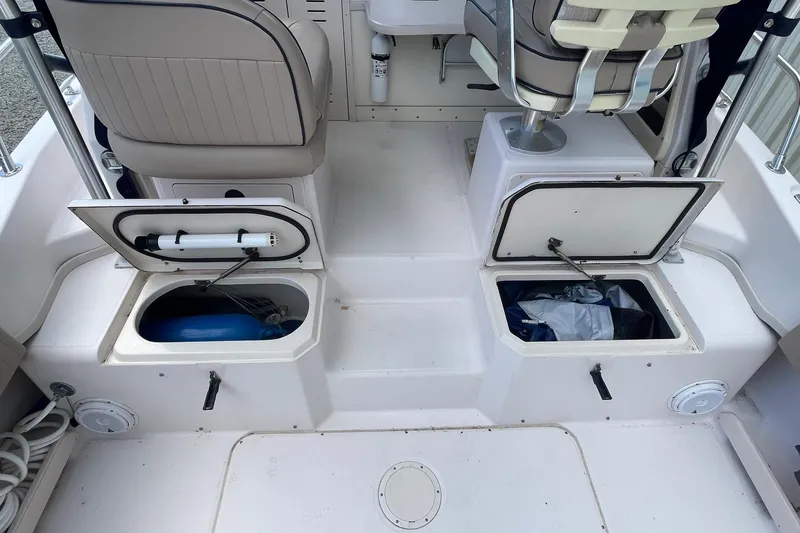 Slide: The Image of 2001 Grady-White Sailfish 255 boat interior with open storage compartments and seating. - 26