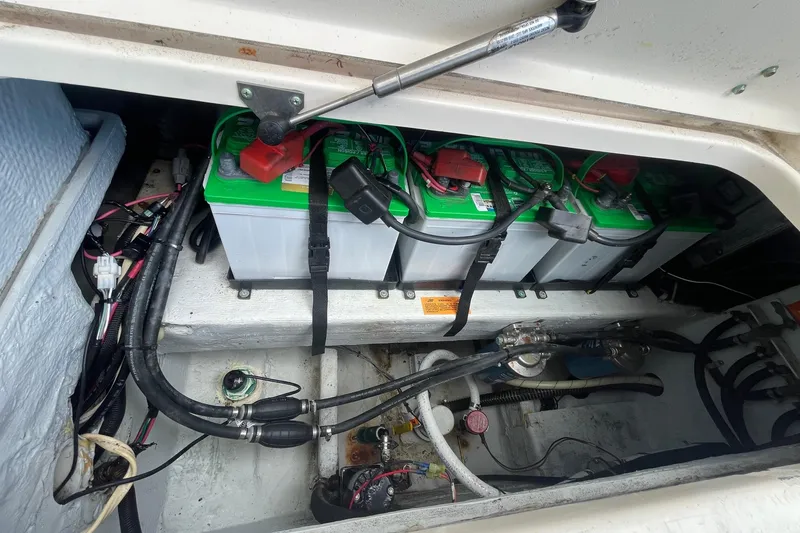 Slide: The Image of Battery compartment of 2001 Grady-White Sailfish 255 boat, showing multiple batteries and wiring. - 29