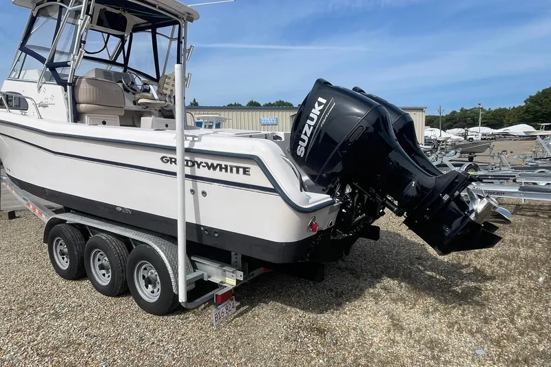 Slide: The Image of 2001 Grady-White Sailfish 255 boat with Suzuki outboard motor on trailer. - 3