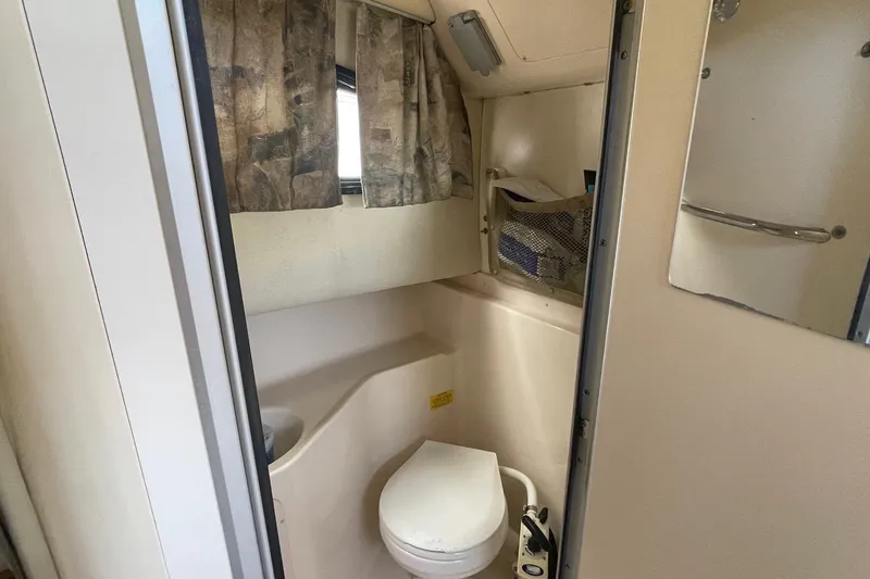 Slide: The Image of 2001 Grady-White Sailfish 255 boat bathroom interior with toilet and window. - 33