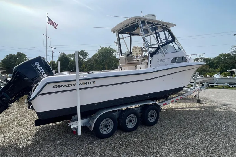 Slide: The Image of 2001 Grady-White Sailfish 255 boat on trailer with Suzuki outboard motor. - 5