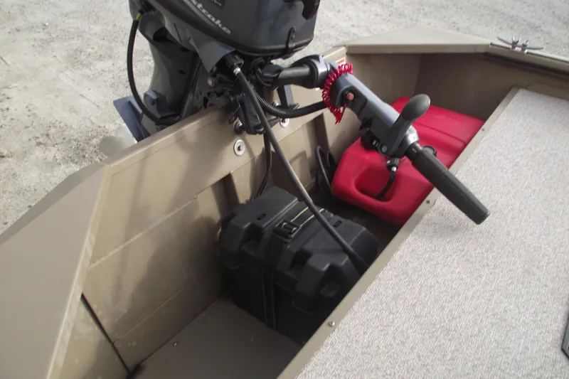 Slide: The Image of 2022 SeaArk DXS 1548 DKLD boat interior with motor and storage compartments. - 13