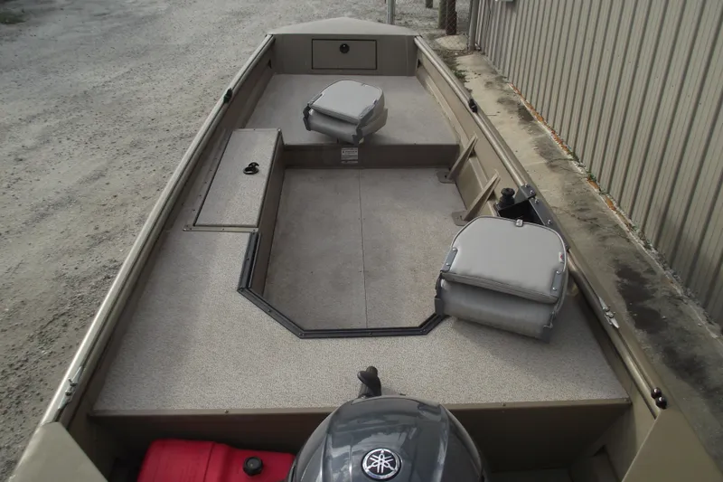 Slide: The Image of 2022 SeaArk DXS 1548 DKLD boat interior with seating and storage compartments. - 17