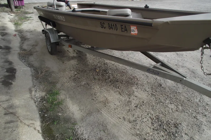 Slide: The Image of 2022 SeaArk DXS 1548 DKLD boat on trailer. - 2