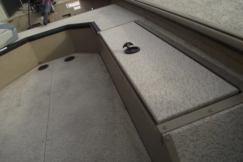 Slide: The Image of 2022 SeaArk DXS 1548 DKLD boat interior with nonskid flooring and storage compartment. - 8