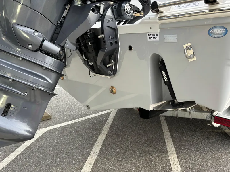 Slide: The Image of 2025 Sea Fox 268 Commander boat engine and transom detail in a parking lot. - 18