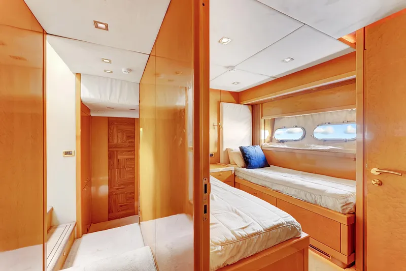 Slide: The Image of Luxurious cabin interior of 2007 Sunseeker Predator 108 yacht with twin beds and porthole windows. - 32