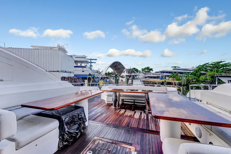 Slide: The Image of Luxurious 2007 Sunseeker Predator 108 yacht deck with seating and tables, docked at marina. - 36