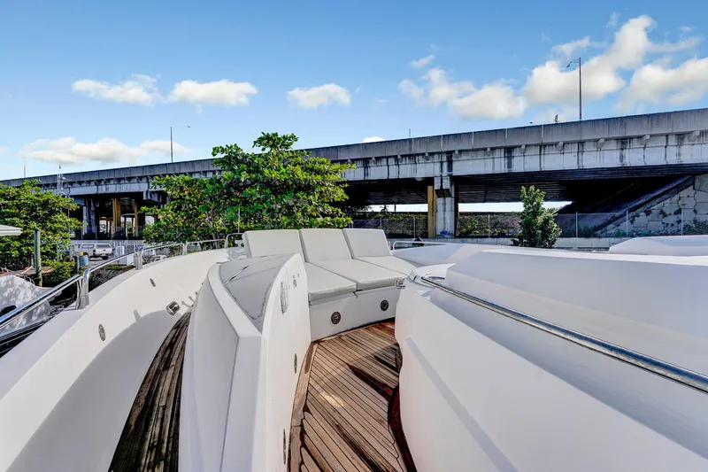Slide: The Image of 2007 Sunseeker Predator 108 yacht deck with seating, under a bridge, clear sky. - 38