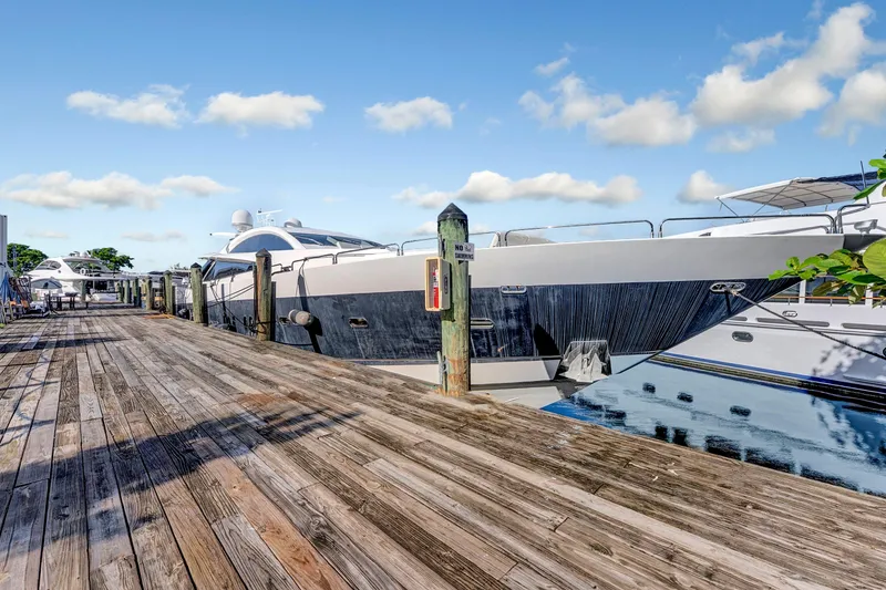 Slide: The Image of 2007 Sunseeker Predator 108 yacht docked at a wooden pier under a clear blue sky. - 46