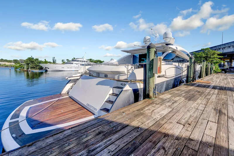 Slide: The Image of 2007 Sunseeker Predator 108 yacht docked at a wooden pier under a clear blue sky. - 48