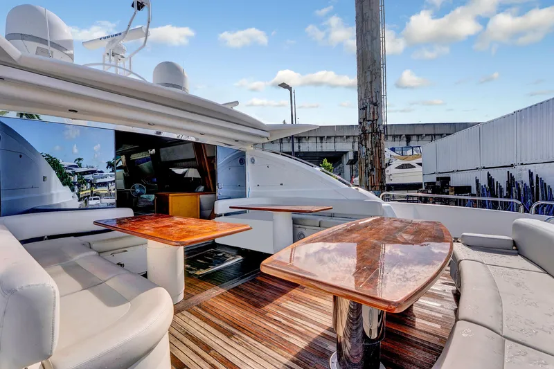 Slide: The Image of Luxurious 2007 Sunseeker Predator 108 yacht with elegant wooden tables and plush seating. - 5