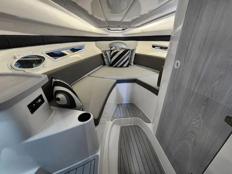 Slide: The Image of 2025 Hanover 305 Inboard boat interior with modern seating and stylish cushions. - 10