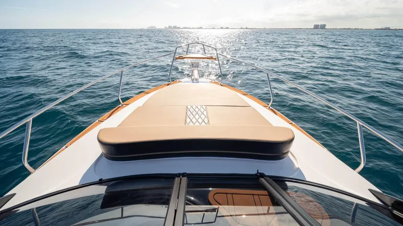 Slide: The Image of 2025 Hanover 305 Inboard boat cruising on open sea under clear skies. - 5