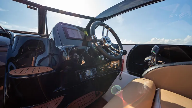 Slide: The Image of Interior view of 2025 Hanover 305 Inboard boat, featuring sleek dashboard and steering wheel. - 8
