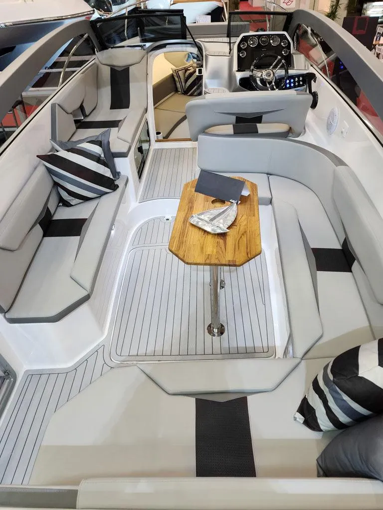 Slide: The Image of Luxurious 2025 Hanover 305 Inboard boat interior with modern seating and sleek design. - 9
