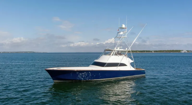 The Image of Custom Ebony Sportfish 65 Convertible yacht, 2004 model, cruising on calm blue waters. - 0