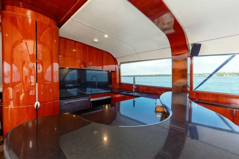 Slide: The Image of Luxurious interior of 2004 Custom Ebony Sportfish 65' CNV yacht with sleek wood finishes. - 12