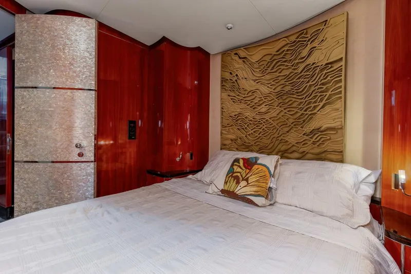 Slide: The Image of Luxurious bedroom interior of 2004 Custom Ebony Sportfish 65' CNV yacht with elegant wood paneling. - 17