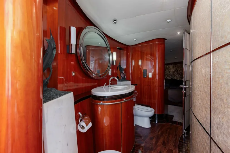 Slide: The Image of Luxurious bathroom interior on 2004 Custom Ebony Sportfish 65' CNV yacht, featuring elegant wood finishes. - 19
