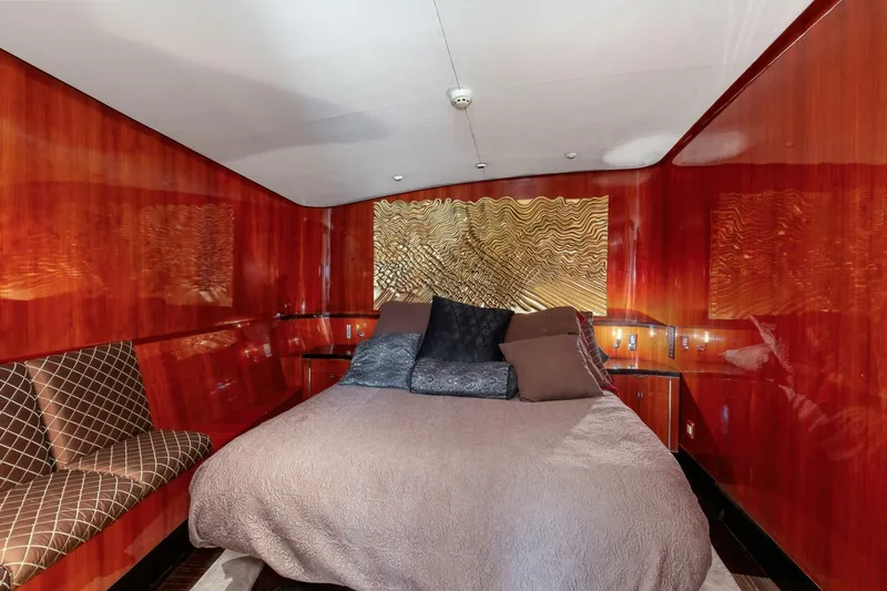Slide: The Image of Luxurious bedroom interior of 2004 Custom Ebony Sportfish 65' CNV yacht with elegant wood paneling. - 21