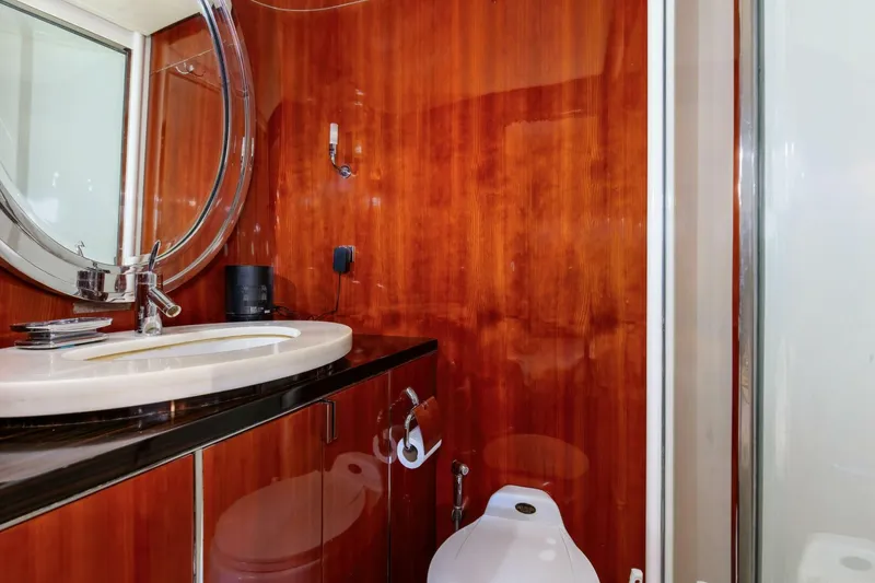 Slide: The Image of Luxurious bathroom in 2004 Custom Ebony Sportfish 65' CNV yacht with wood paneling. - 24