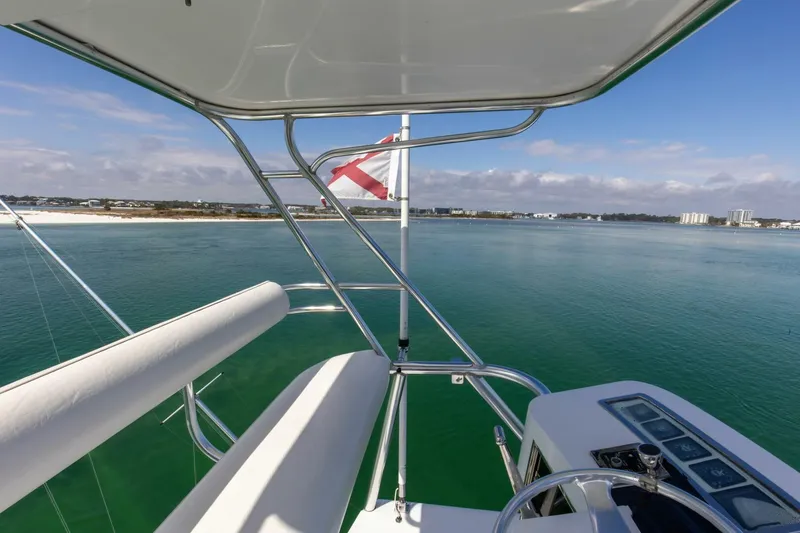 Slide: The Image of View from the helm of a 2004 Custom Ebony Sportfish 65' CNV yacht, overlooking calm waters. - 29
