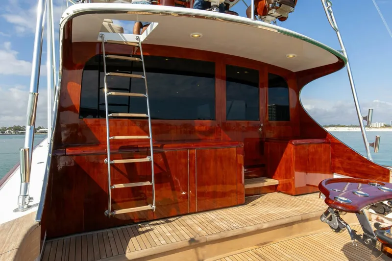 Slide: The Image of Custom Ebony Sportfish 65' CNV 2004 yacht with polished wood finish and ladder on deck. - 31