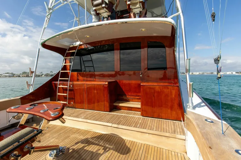 Slide: The Image of Custom Ebony Sportfish 65' CNV yacht, 2004 model, with polished wood deck and ladder. - 32
