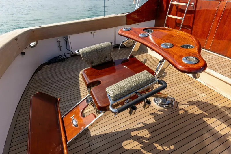 Slide: The Image of Luxurious 2004 Custom Ebony Sportfish 65' CNV yacht deck with polished wood seating. - 33