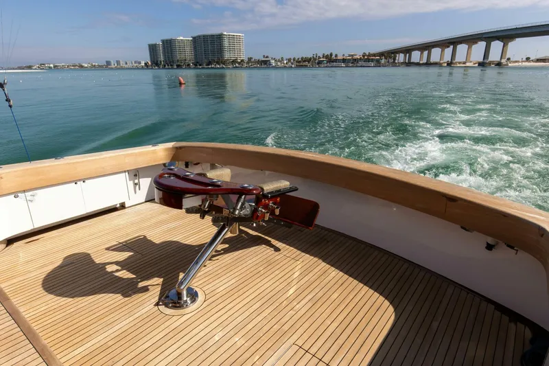 Slide: The Image of Custom Ebony Sportfish 65' CNV 2004 yacht deck with ocean view and cityscape background. - 36